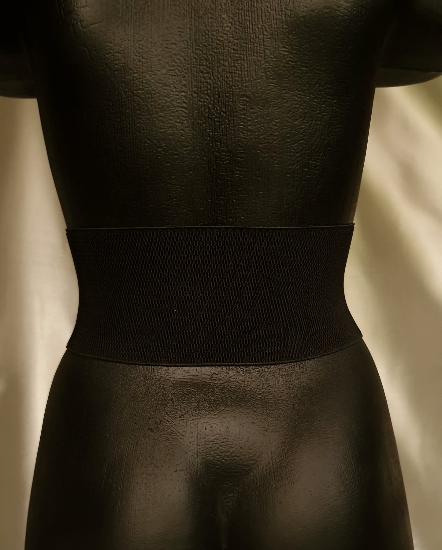 Back of dragon corset showing strong black elastic band and hand-stitched leather attachment