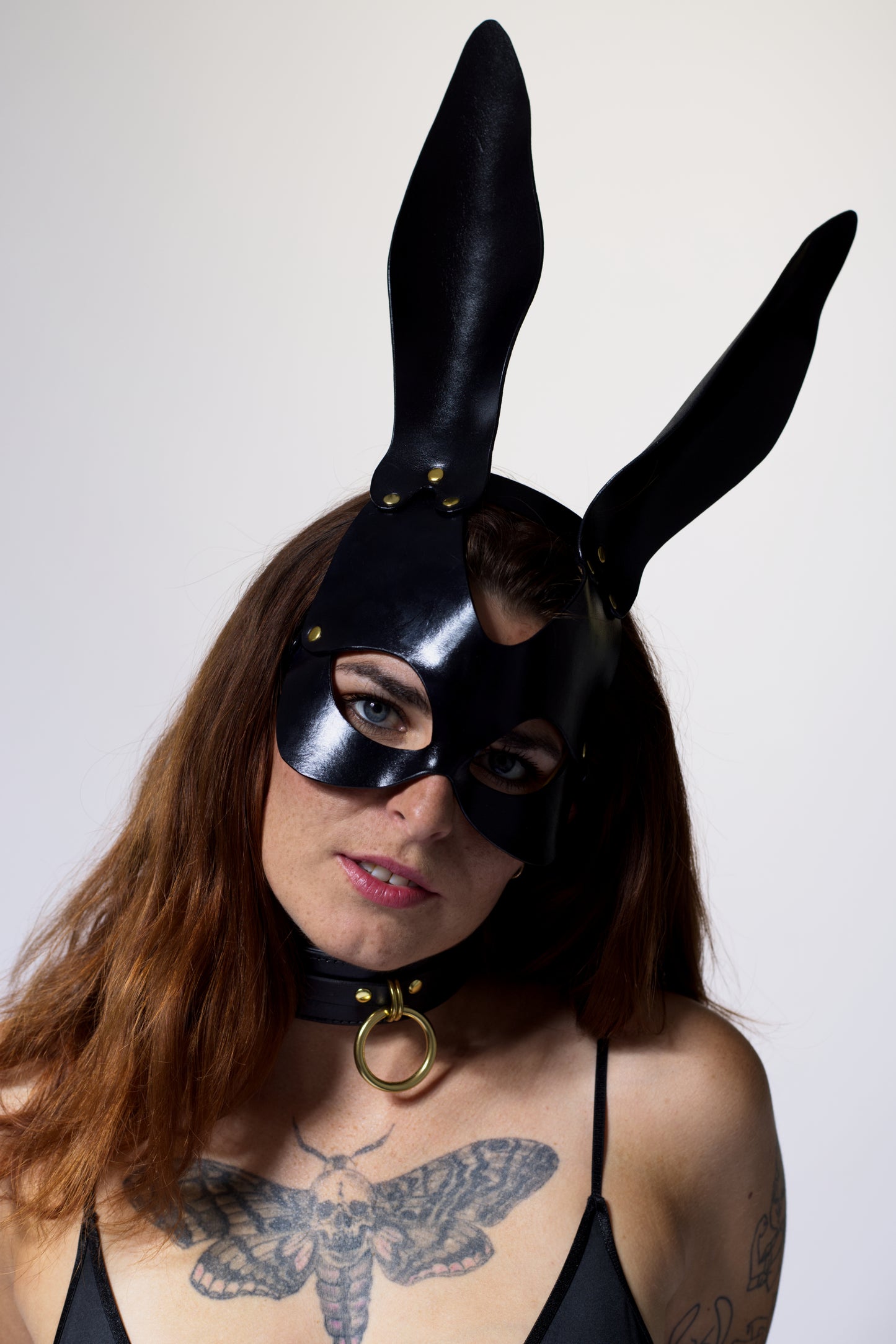 Front view leather bunny mask in black.