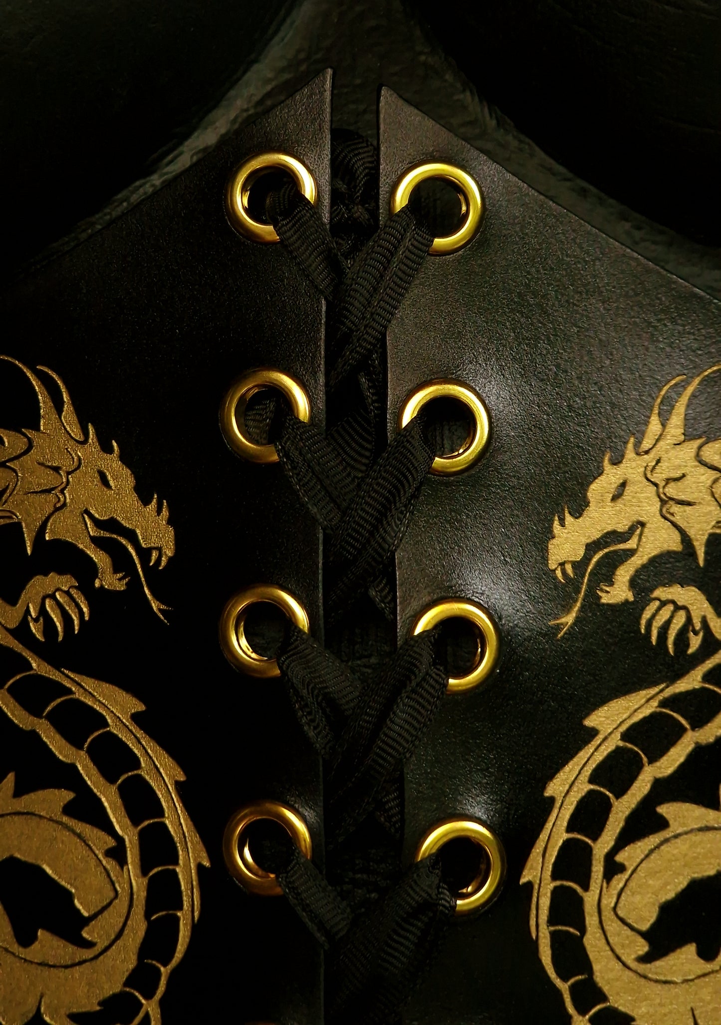 Close-up of hand-burnished edges on vegetable-tanned BDSM corset with handmade stitching