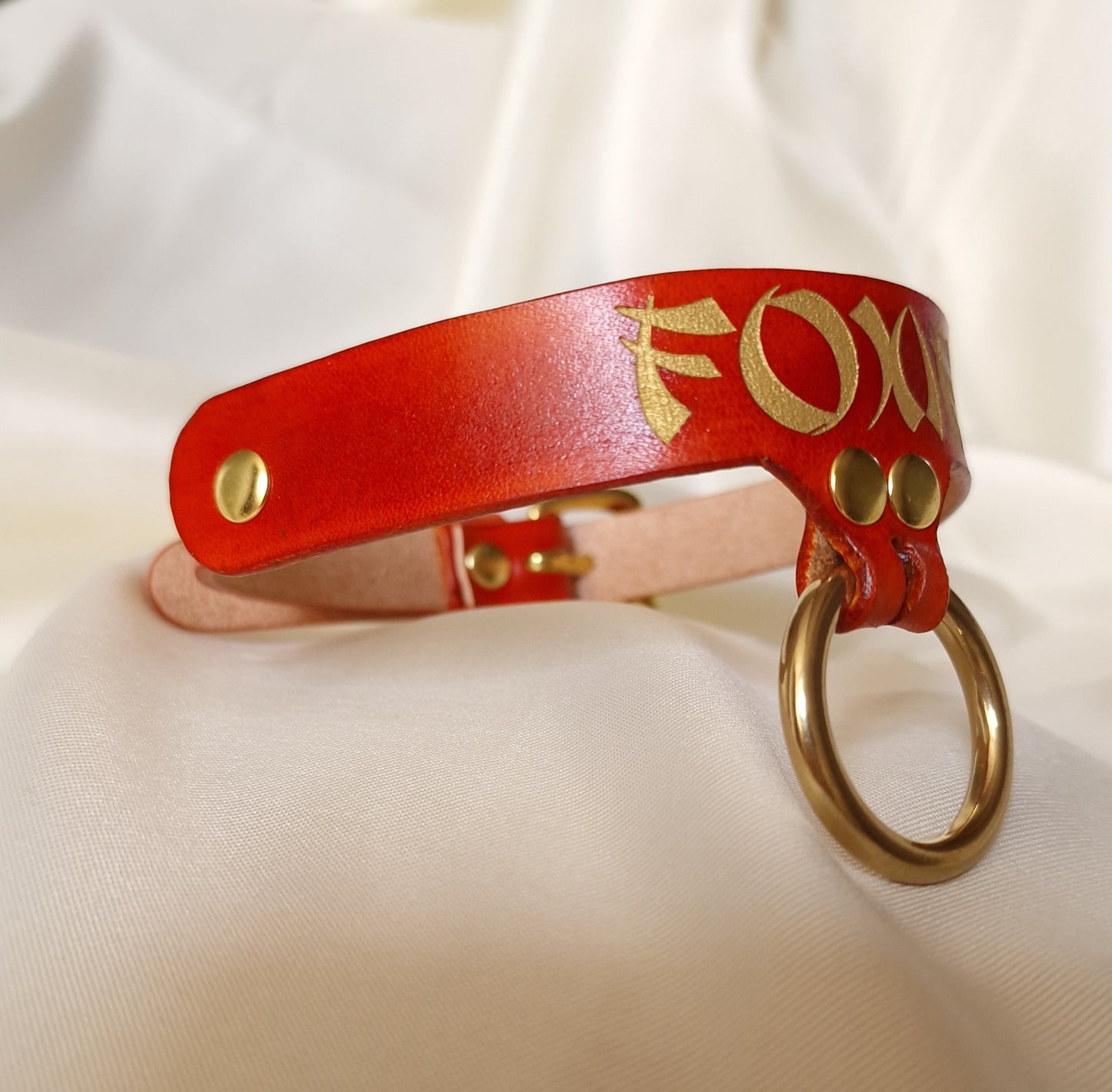 Side view of custom engraved leather choker showing engraved and painted details