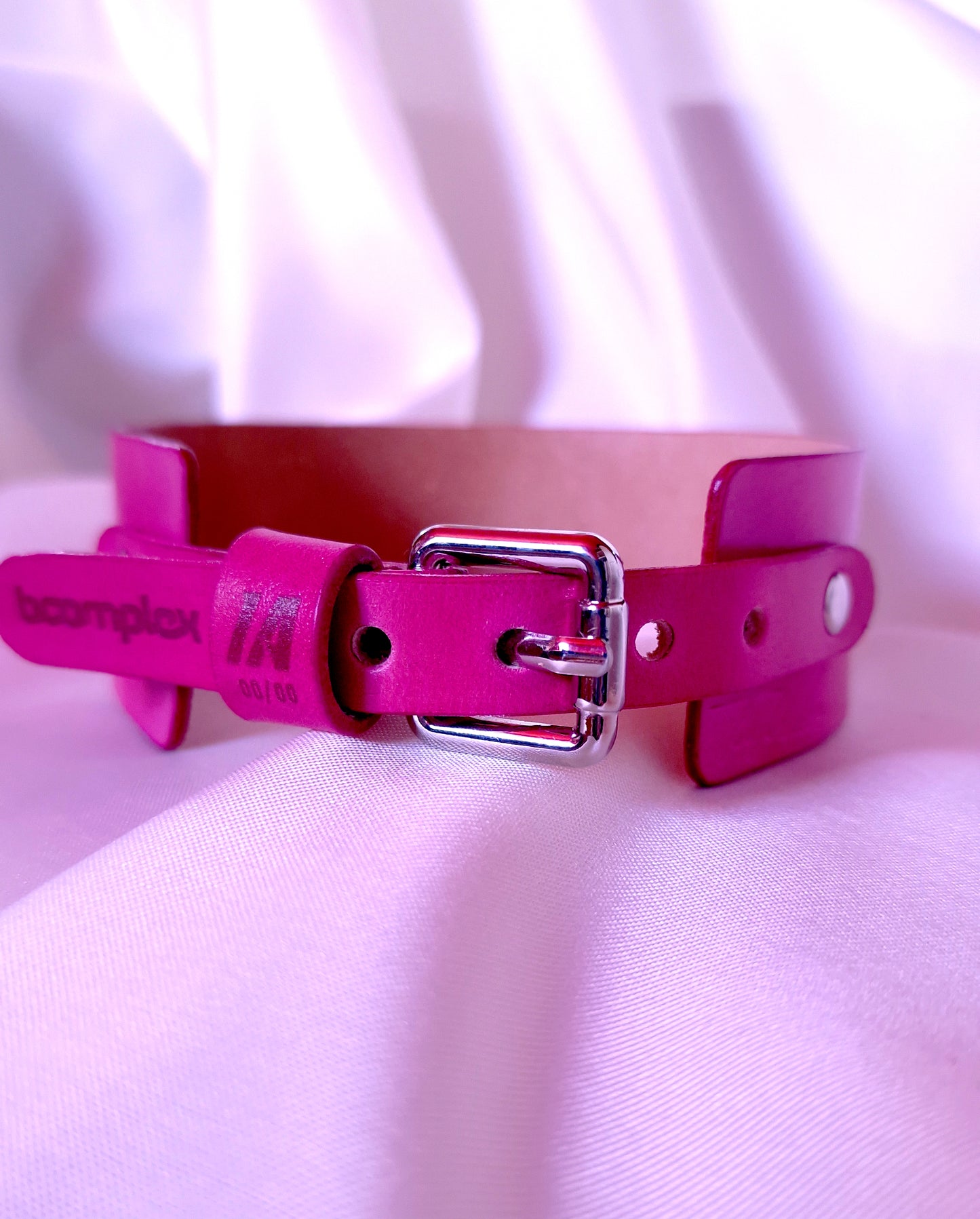 Back view of the pink leather choker with adjustable strap and engraved logo