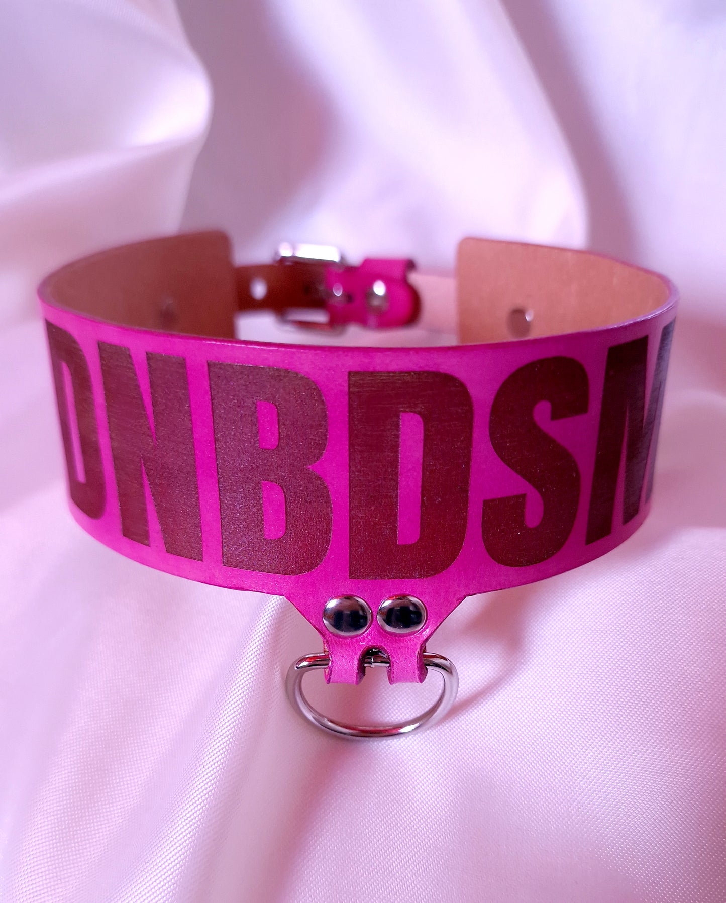 This angle showing burnished edges and silver hardware of the DNBDSM choker