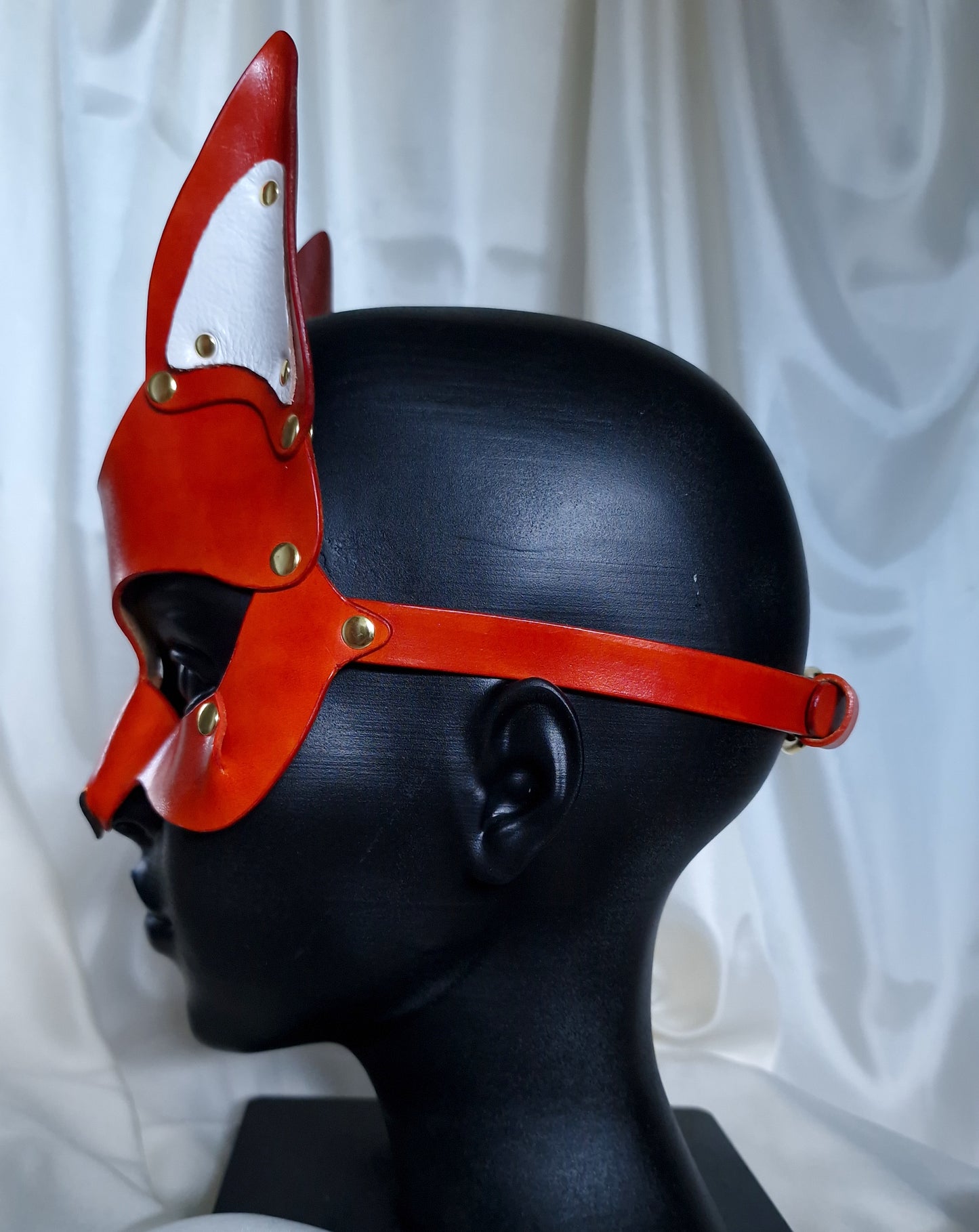 Side profile of vulpine mask for fetish fashion.