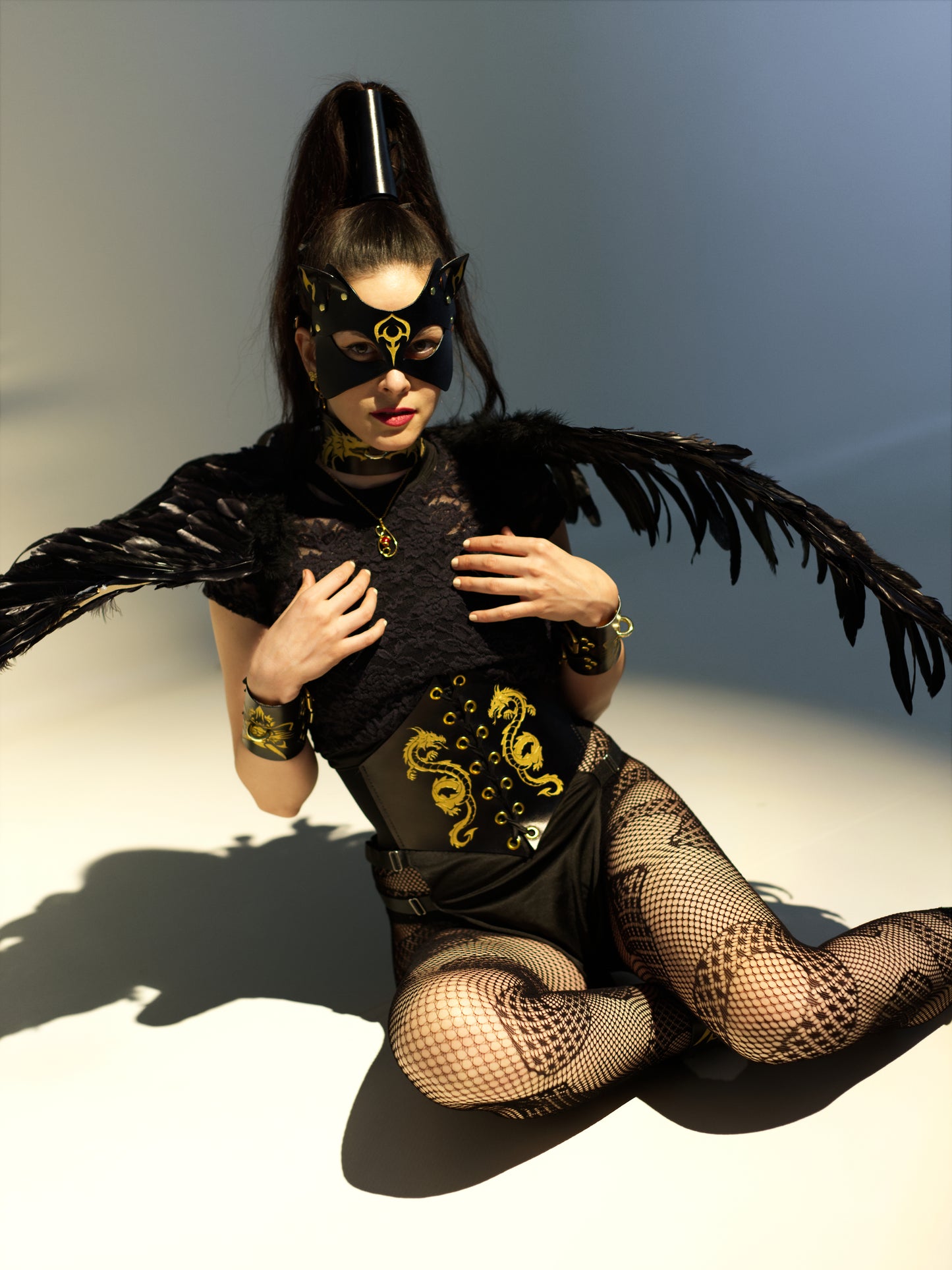Complete dragon ensemble with corset and bondage restraints.