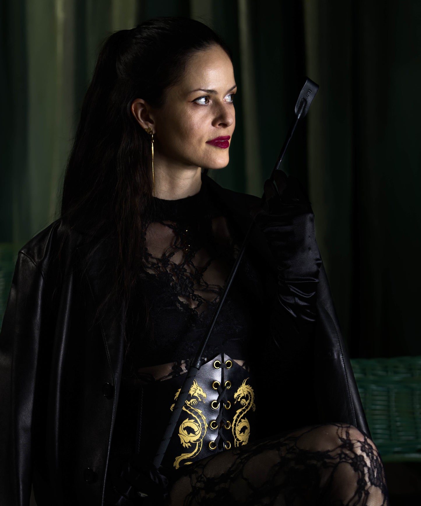 Full body photo of dominatrix in handstitched BDSM corset with engraved dragon – eco-conscious leather fashion