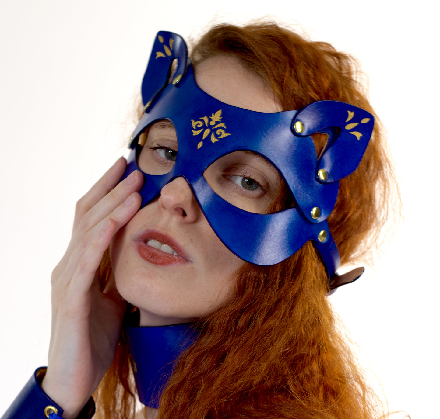 Rococo-inspired feline mask in veg-tanned leather with sculpted fit.