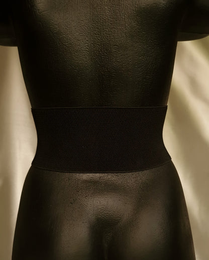 Back of dragon corset showing strong black elastic band and hand-stitched leather attachment