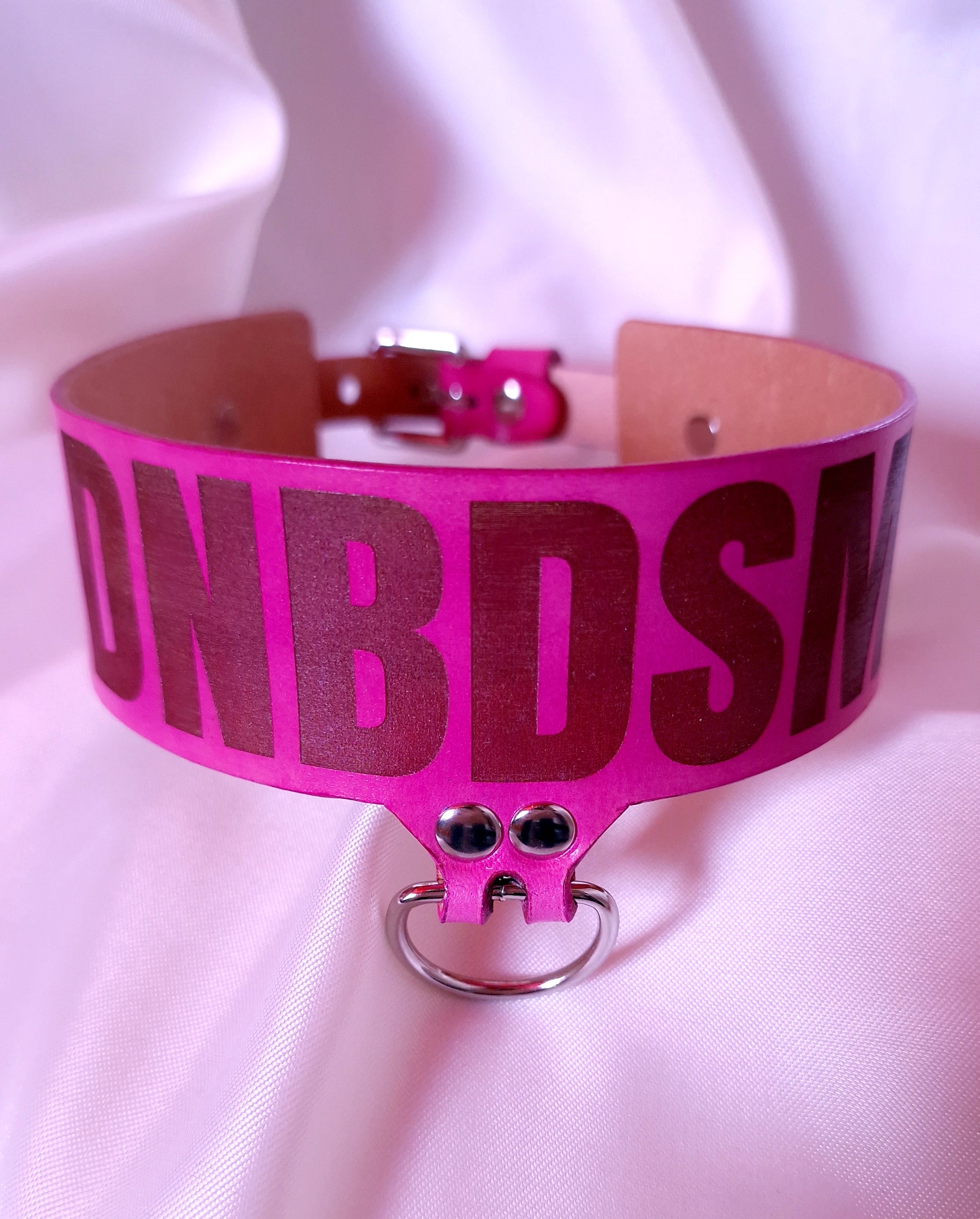 This angle showing burnished edges and silver hardware of the DNBDSM choker