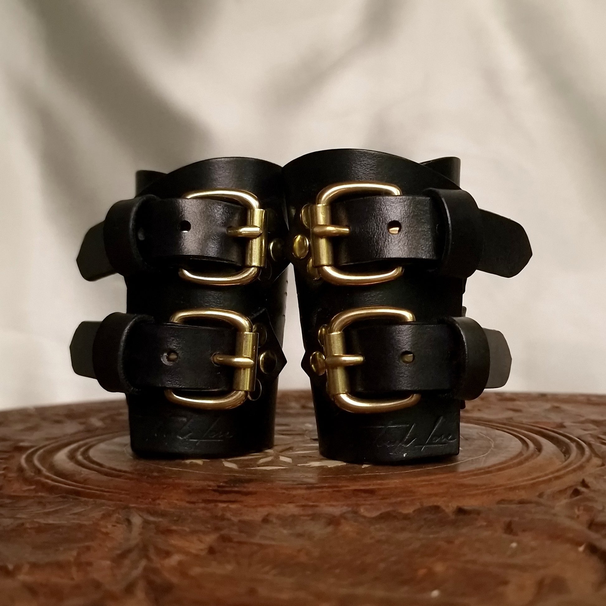 BDSM leather cuffs with D-ring attachments for hogties or leash.