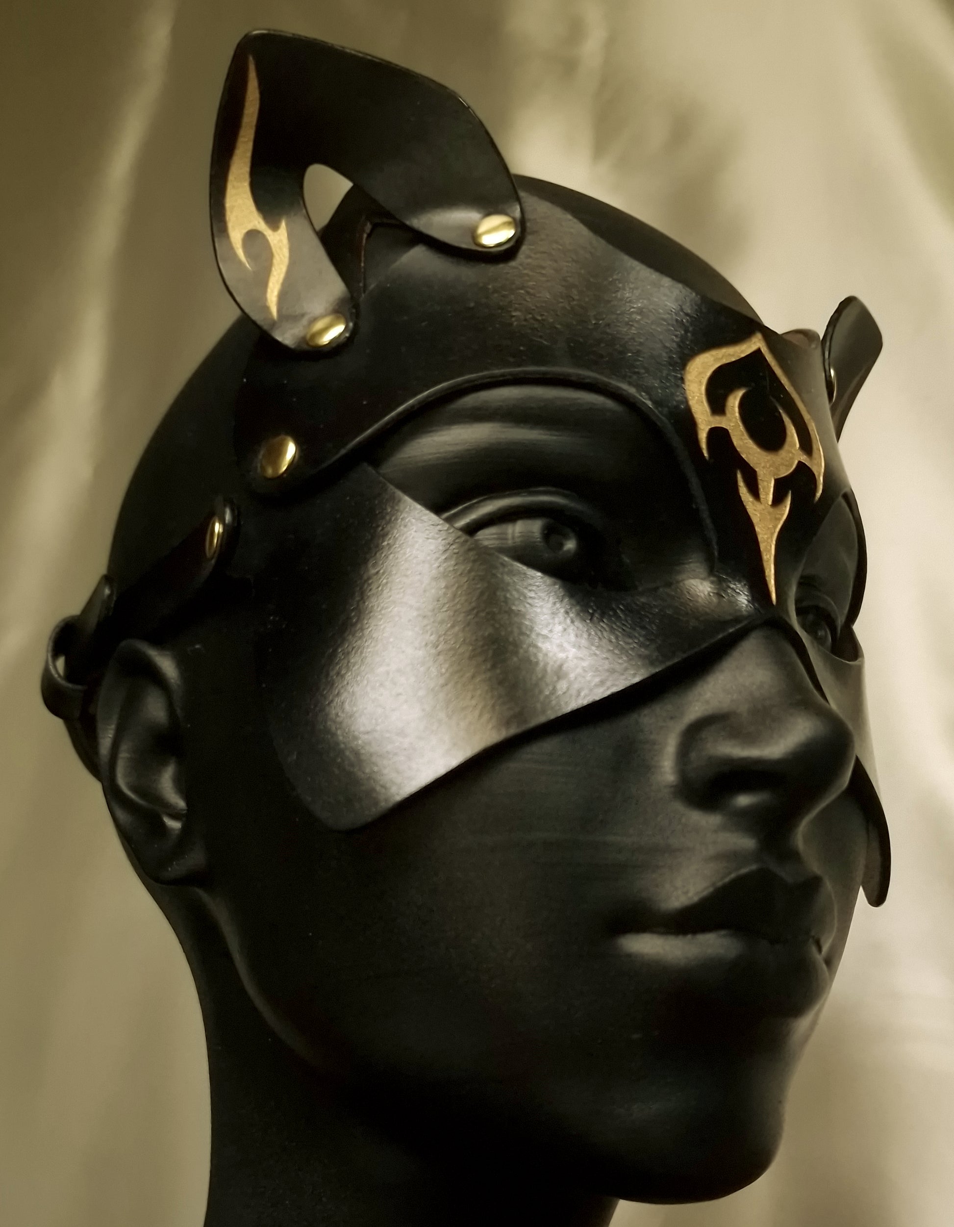 Side profile luna cat mask with ornaments.