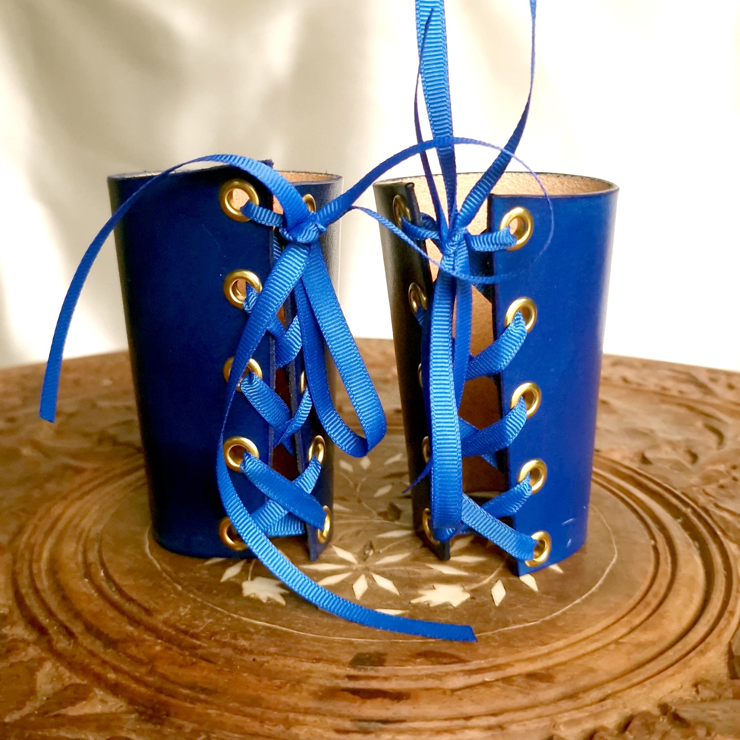 Royal-inspired wrist restraints. Luxury leather cuffs with lacing.