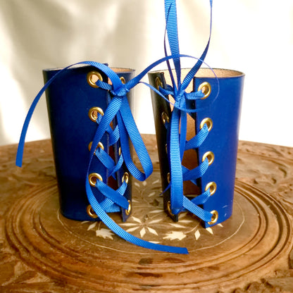 Royal-inspired wrist restraints. Luxury leather cuffs with lacing.