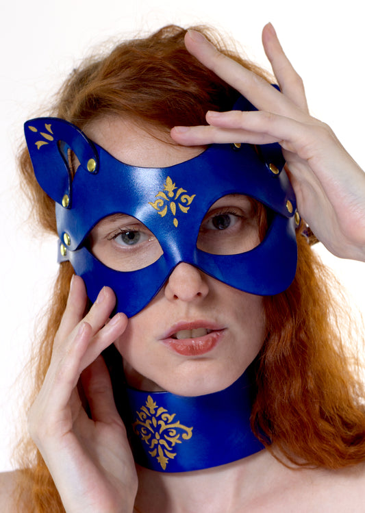 Baroque leather cat mask with engraved filigree, high-end fetish styling.