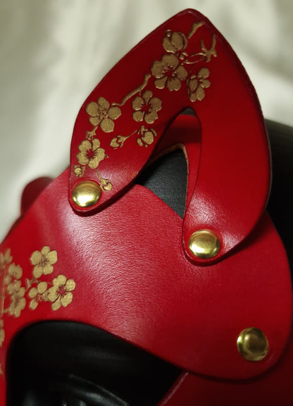 Cherry blossom detail on leather feline mask.