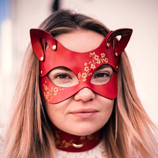 Sakura leather cat mask with engraved gold cherry blossoms, micro-painted details.