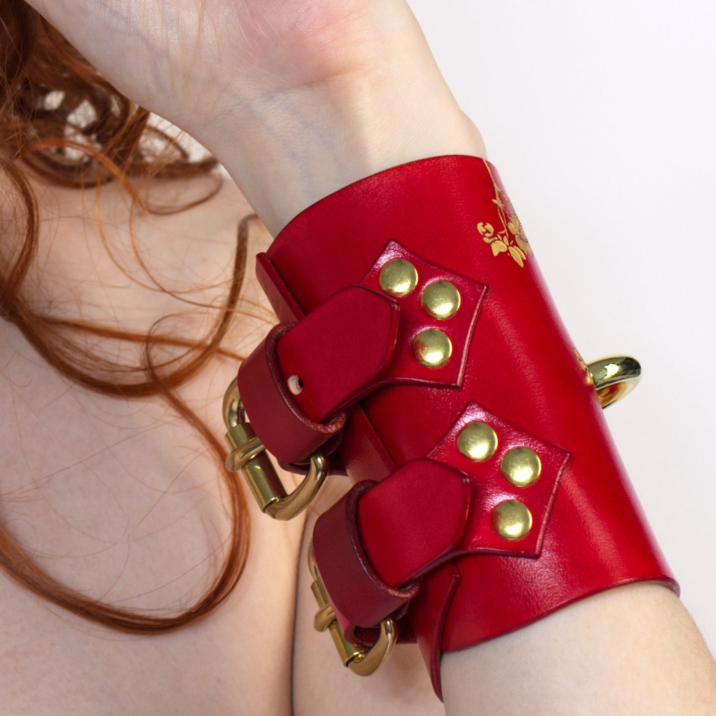 Luxury leather cuffs with floral engraving.