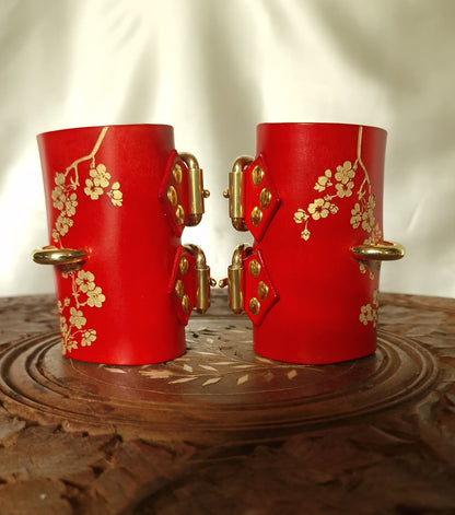 Red sakura cuffs with burnished edges. Vegetable-tanned leather.